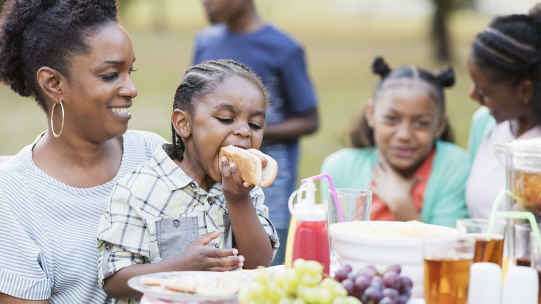 child eating hot dog