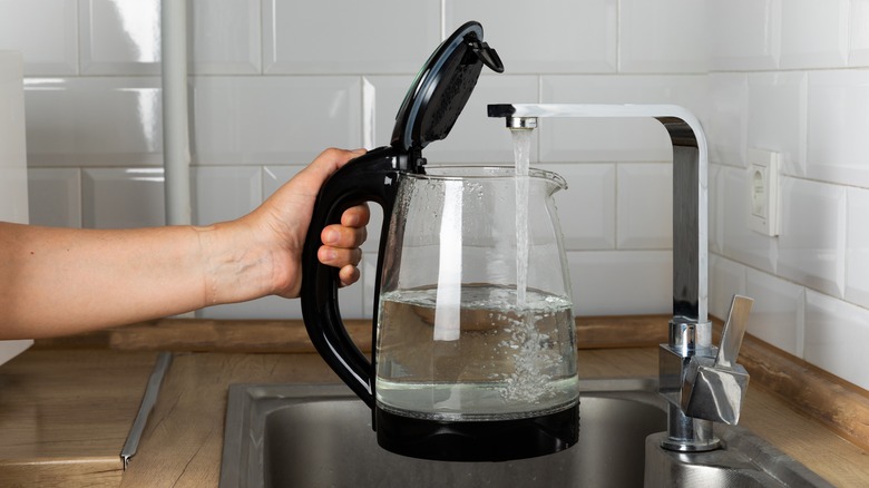 filling up water into electric kettle