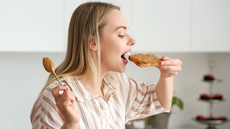 Person eating organic peanut butter