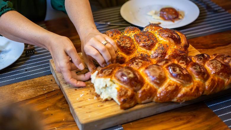 Hands tearing bread