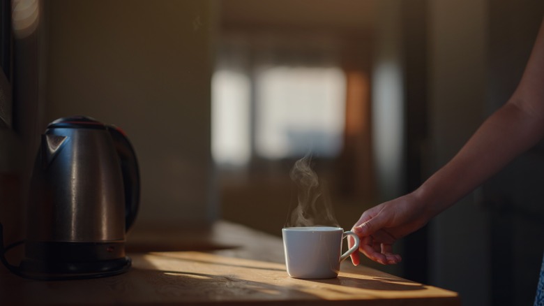 reaching for coffee morning light