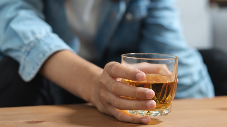 Man holding a glass of whisky 