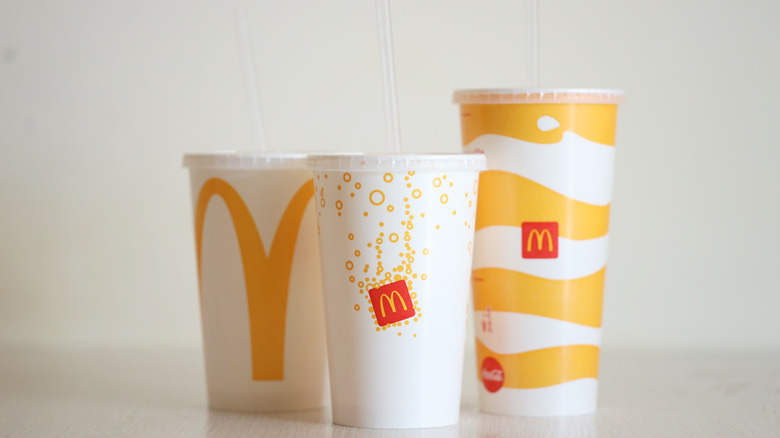 Three different McDonald's cups with a neutral background