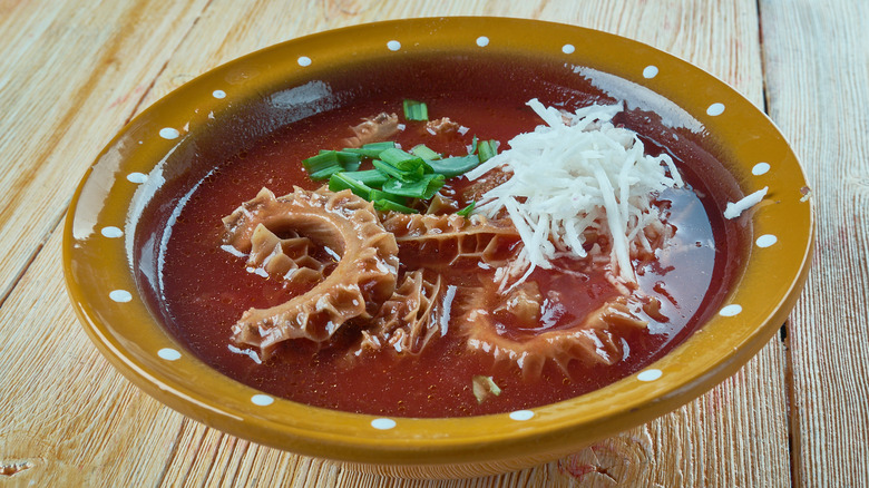 bowl of menudo on wooden table