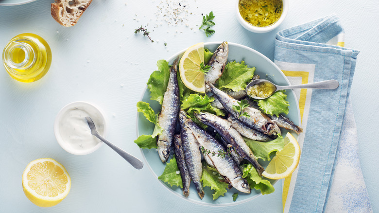 cooked sardines with salad and lemon