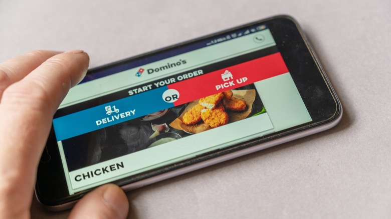 A person orders on the Domino's app