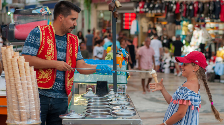 vendor serving child dondurma cone