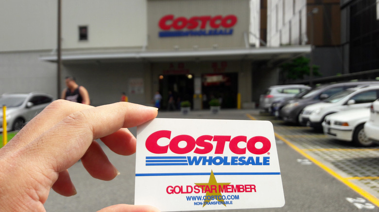 Costco membership card in hand