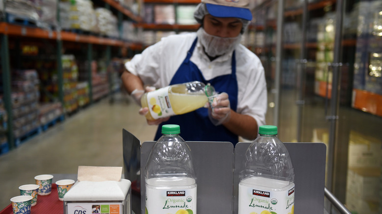 Costco employee serving lemonade samples