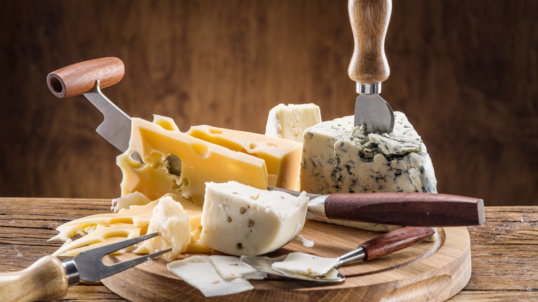 cheese on board with knives