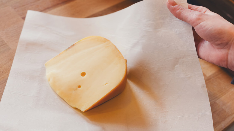 block of cheese being wrapped