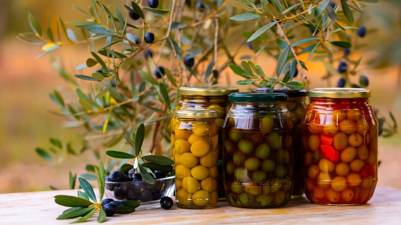 Jars of olives and olive branches