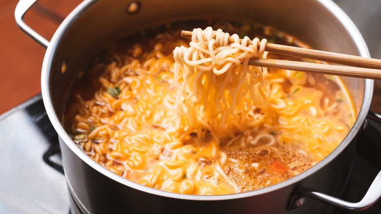 noodles in pot with chopsticks