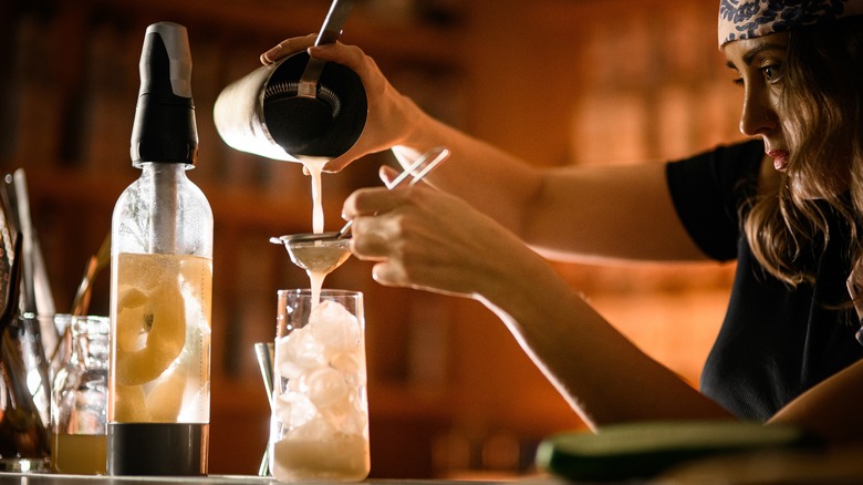 strained drink passing through sieve