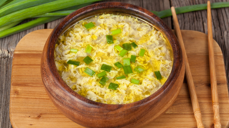 Egg drop in wooden bowl with chopsticks