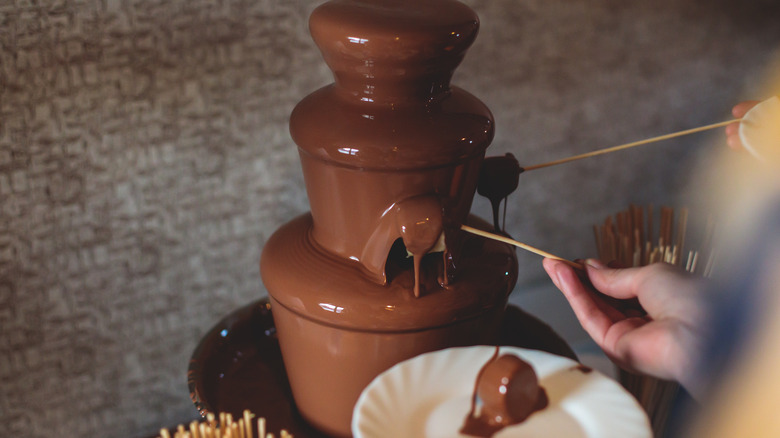 A chocolate fountain being used