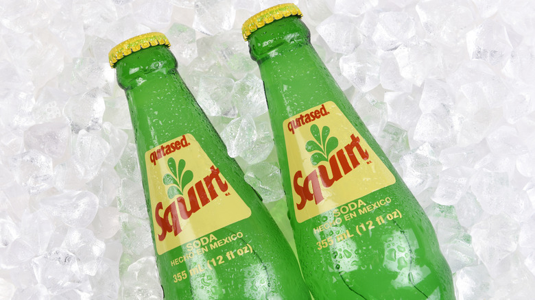 Squirt soda bottles on ice