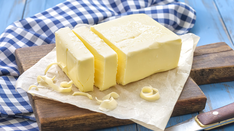 Sliced butter on cutting board