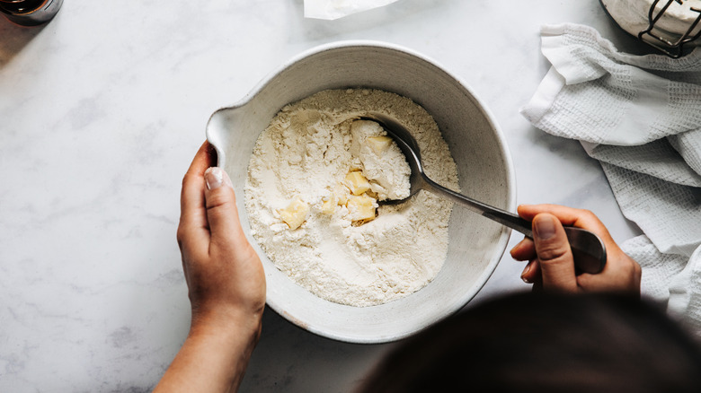 Mixing butter into flour