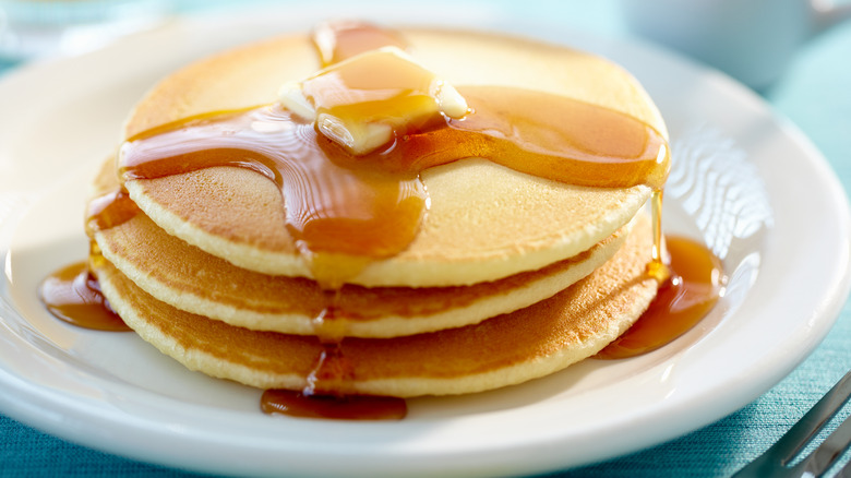 Person pouring kefir into pancake mix