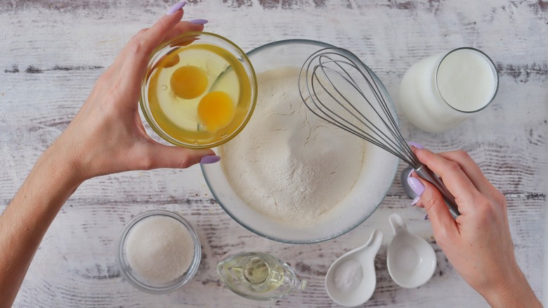 Person mixing together pancake ingredients