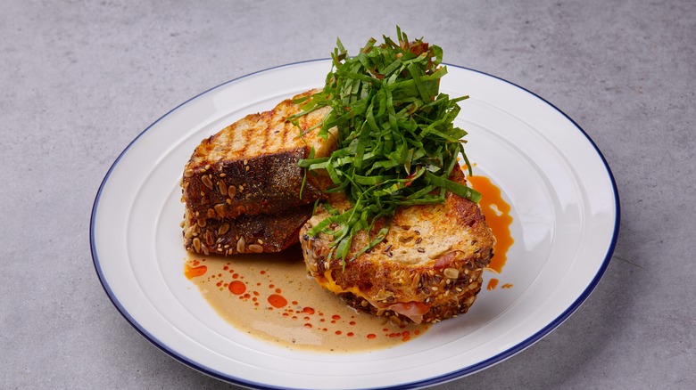 Grilled cheese on plate with herbs