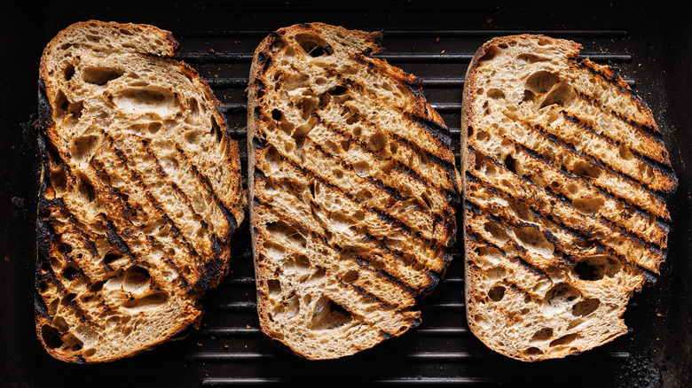 Slices of sourdough bread on a grill