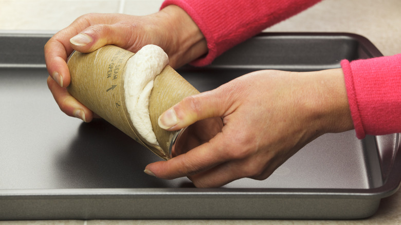 Person opening can of biscuits