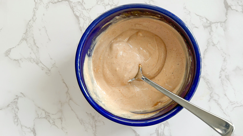 spoon mixing sauce in bowl