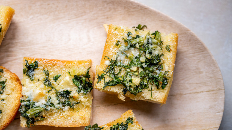 sliced garlic bread on board 