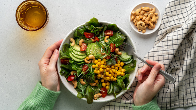 Hands with salad bowl