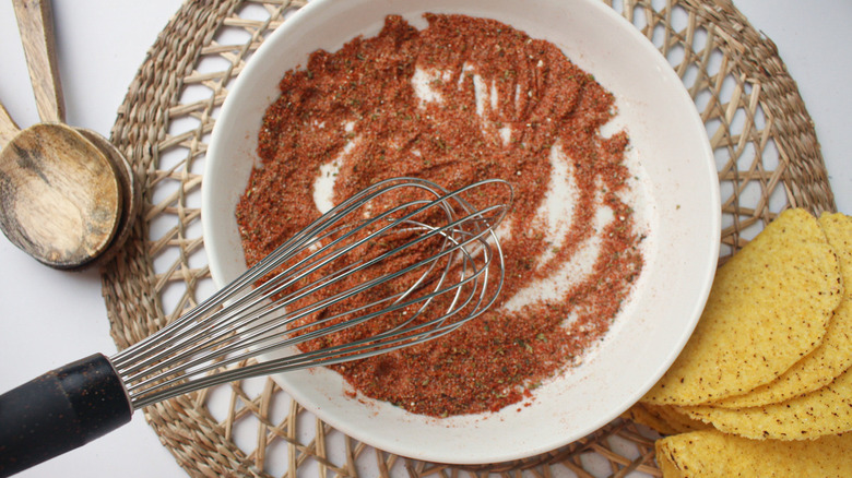 whisk on plate with seasonings