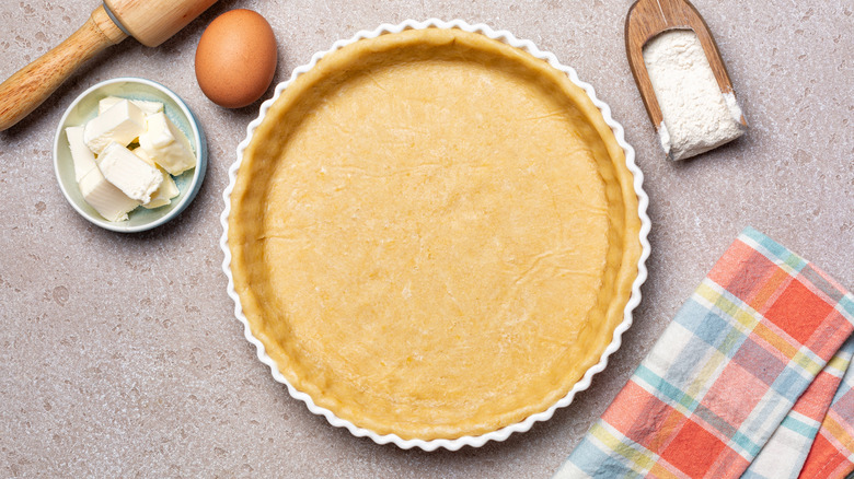 pie crust in dish with rolling pin