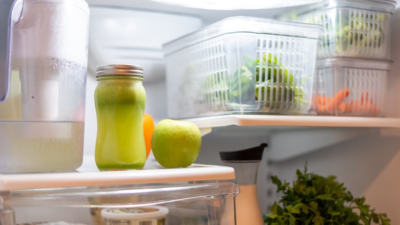 vegetable containers on fridge shelf