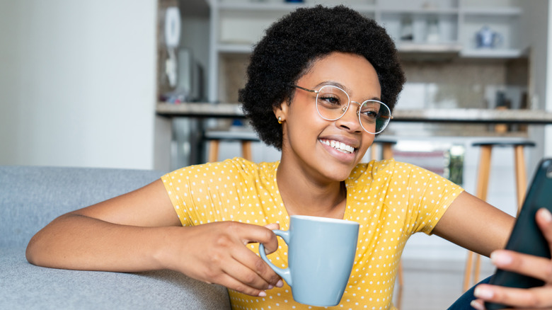 person holding coffee mug