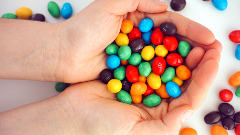 Hands holding M&M's