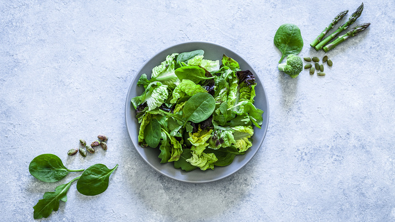 salad greens in white bowl