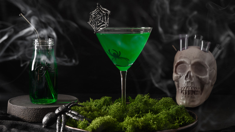 green cocktail with Halloween decorations