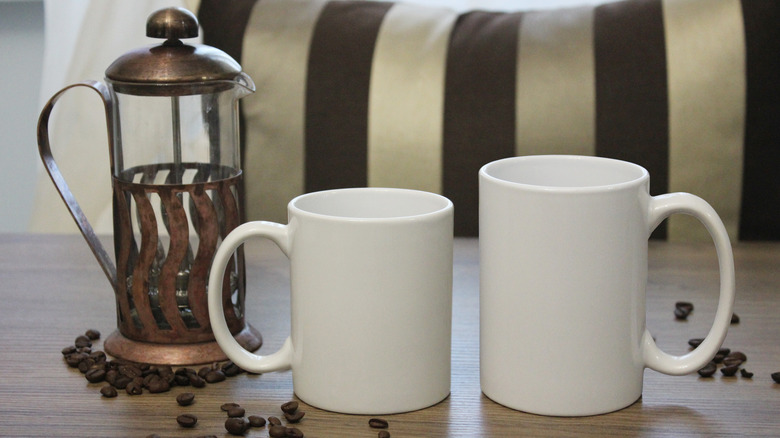 French press with coffee mugs