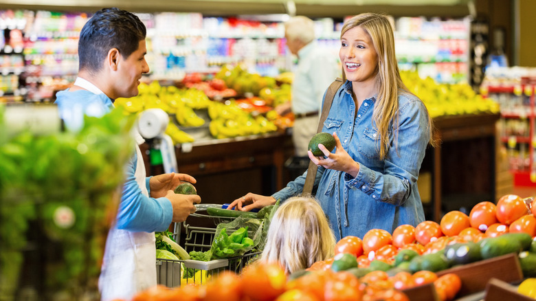 woman shopping for avocados