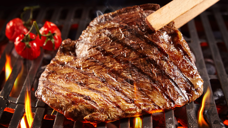 Person searing side of steak