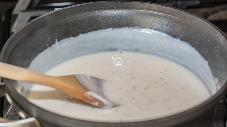 stirring gravy in sauce pan