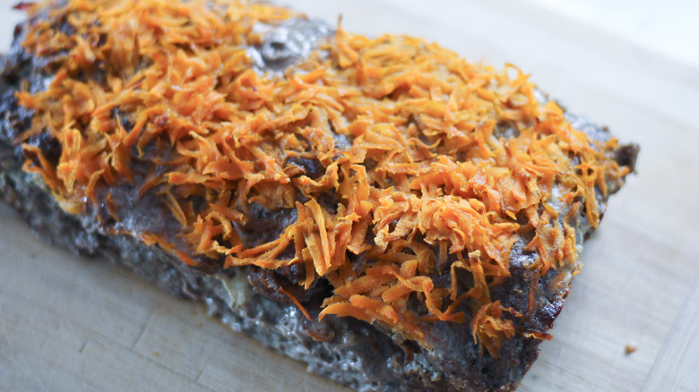 meatloaf and carrots on cutting board