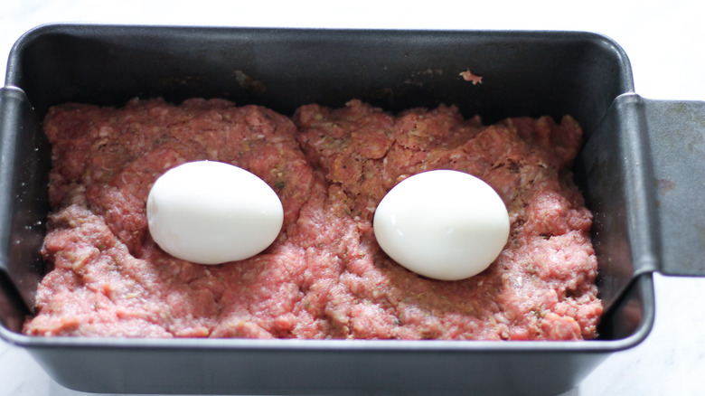 eggs in a pan with ground beef