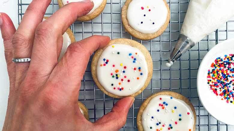 hand holding iced sugar cookie