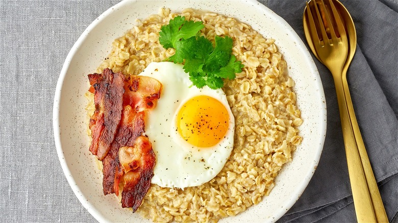 Fried egg and bacon over oatmeal