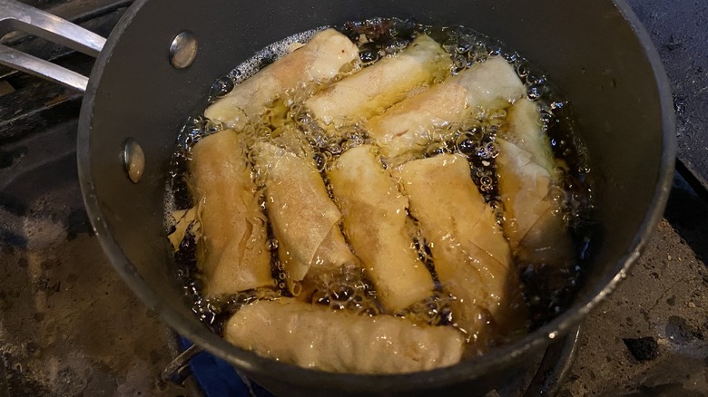 Frying egg rolls in pot