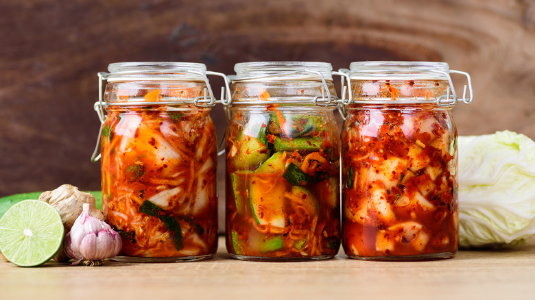 three jars of brightly colored kimchi 