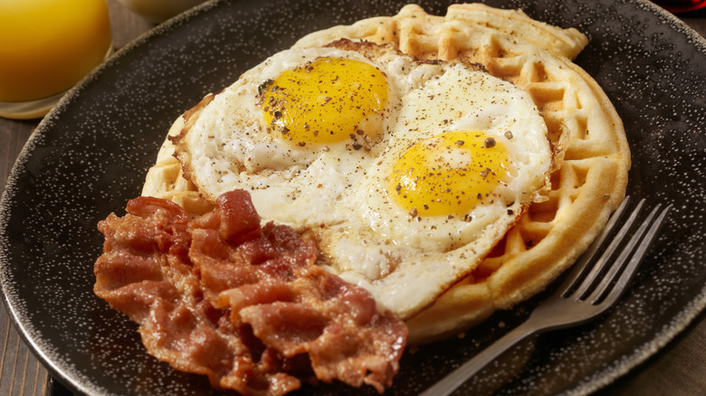 Waffle with fried eggs and bacon