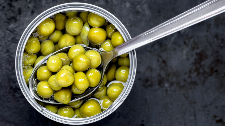 Spoon scooping peas from can